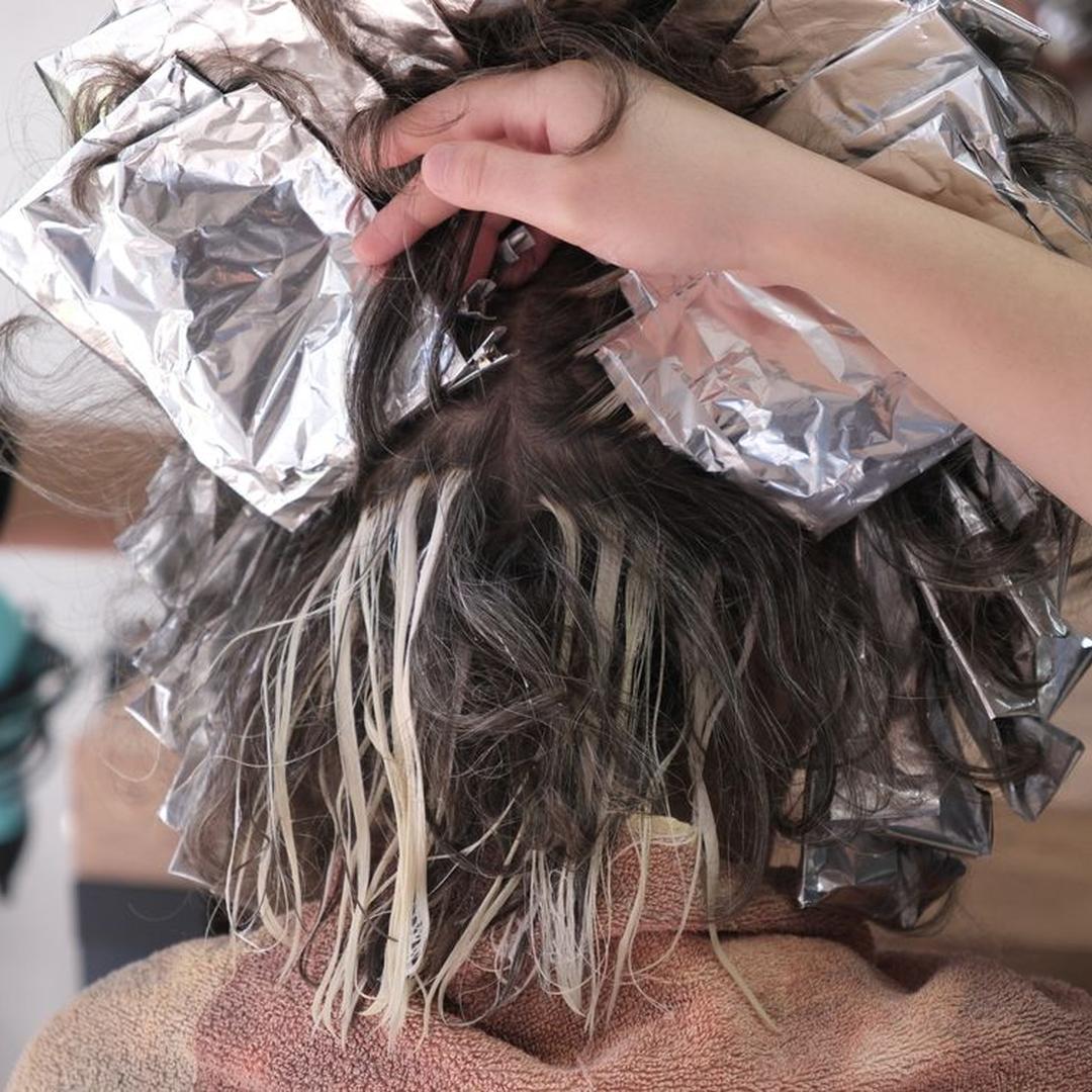Hair coloring process being applied by a colorist